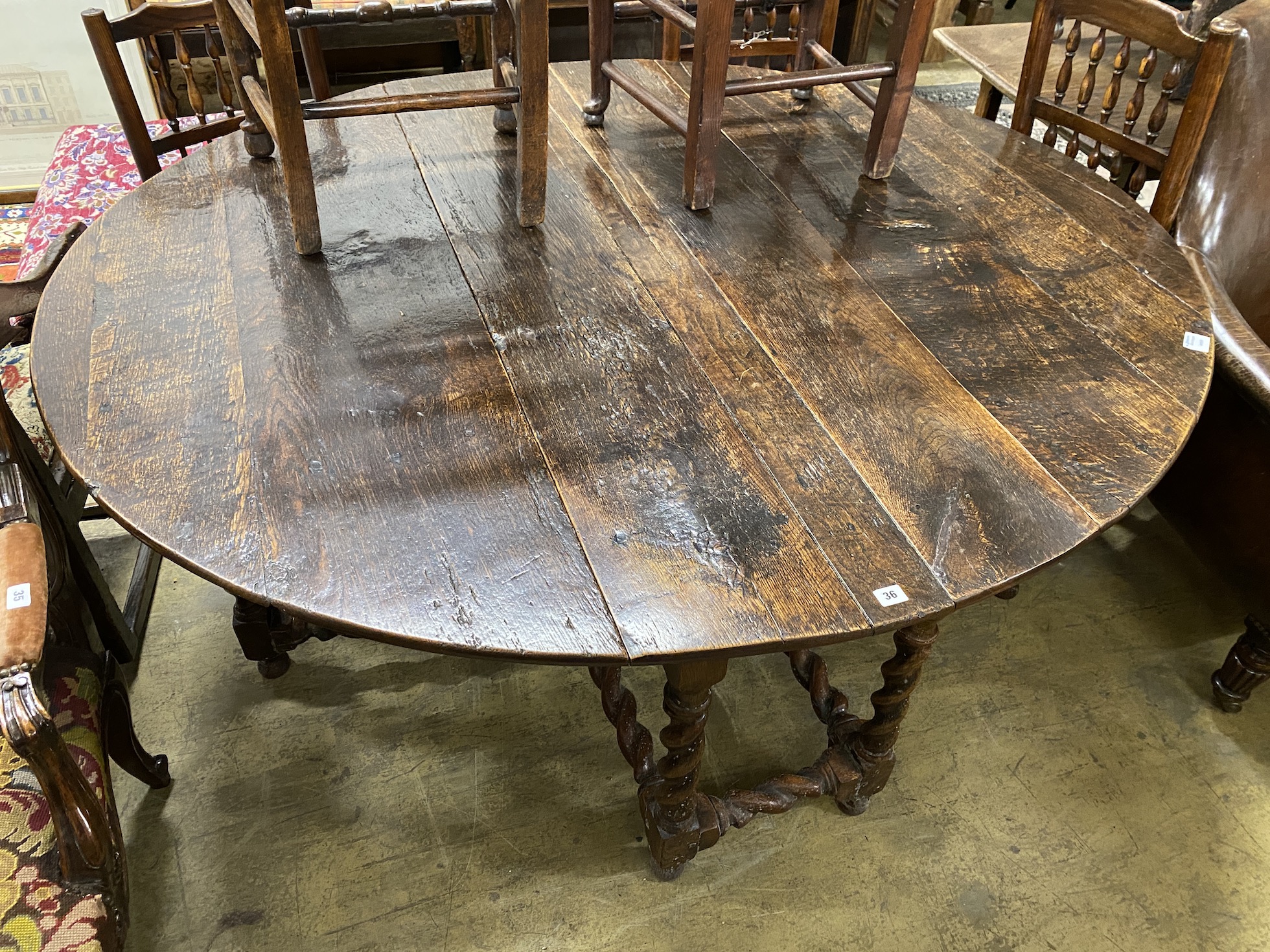 An 18th century oak gateleg dining table, length 172cm, extended, width 152cm, height 73cm